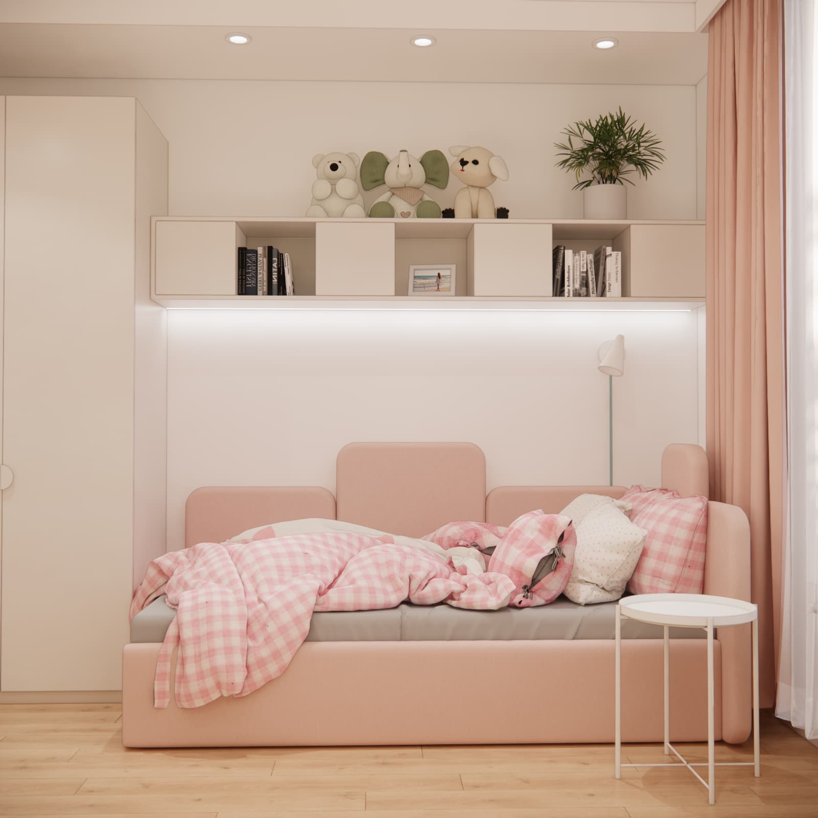 Pink bed with a segmented upholstered backrest, checked bedding and wall cabinets above the sleeping area